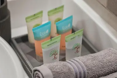 a close up of a shelf with four bottles of soap at Luxury 2BR at Seven Palm Rooftop Pool&Beach Access in Dubai