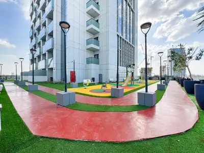 a park with a playground in front of a building at Stylish 1 BR in Cloud Tower in Dubai