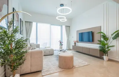 a living room with a couch and a tv at Dream Apartment with Burj Khalifa & Fountain Views in Dubai