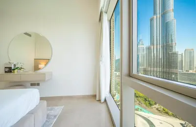 a bedroom with a window with a view of the city at Dream Apartment with Burj Khalifa & Fountain Views in Dubai