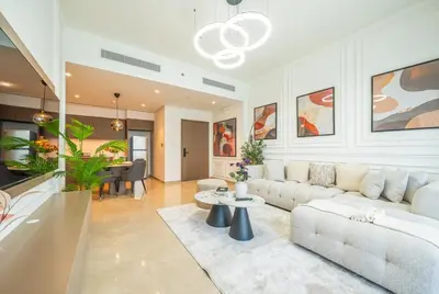 a living room with a couch and a table at Dream Apartment with Burj Khalifa & Fountain Views in Dubai