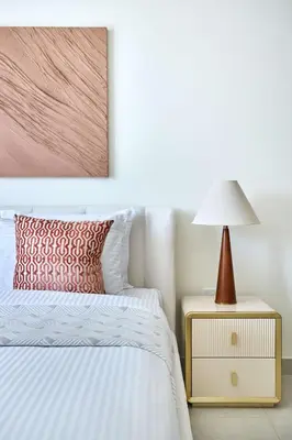 a bedroom with a bed and a lamp on a night stand at Frank Porter - Beach Mansion in Dubai