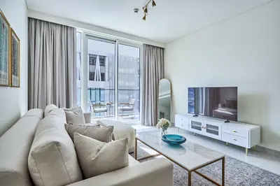 a living room with a couch and a tv at Frank Porter - Beach Mansion in Dubai