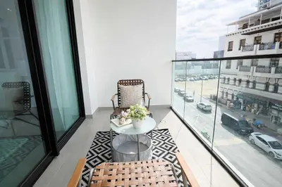 a balcony with a table and chairs on a building at Contemporary Studio with Premium Design in JVC in Dubai