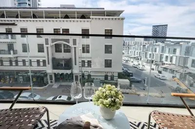 a table on a balcony with a view of a city at Contemporary Studio with Premium Design in JVC in Dubai