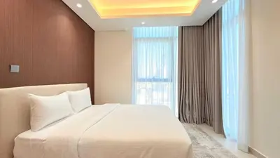 a bedroom with a large white bed and a window at Cloud Tower 1br With Parking Pool Gym & Sports Facilities in Dubai