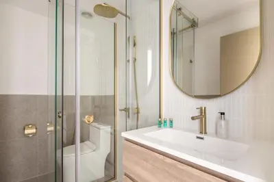 a bathroom with a sink and a mirror at Upgraded apartment just steps away from JBR beach in Dubai