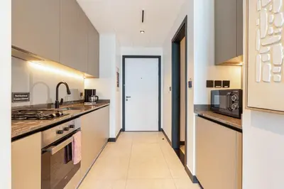 a kitchen with a hallway leading to a door at Central Modern Studio with Floor to Ceiling Windows in Dubai
