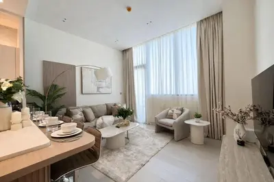 a living room with a couch and a table at Elegant 1BR Haven at Binghatti Phantom in Dubai