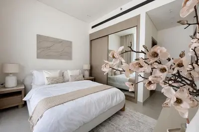 a bedroom with a bed and a flower arrangement at Elegant 1BR Haven at Binghatti Phantom in Dubai
