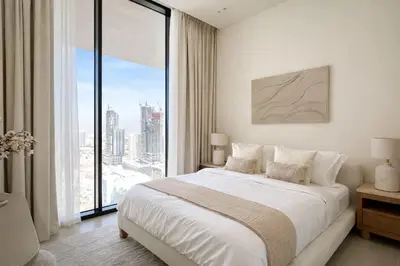 a bedroom with a large bed and a large window at Elegant 1BR Haven at Binghatti Phantom in Dubai