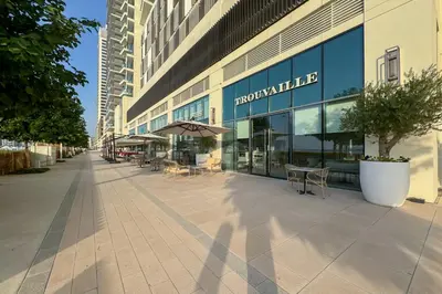 an empty sidewalk in front of a building at Miami Vibes - 1BR with Private Beach, Sea, Palm View in Dubai