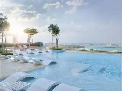 a swimming pool with white chairs and the ocean at Miami Vibes - 1BR with Private Beach, Sea, Palm View in Dubai