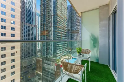 a balcony with a table and chairs and a view of a city at Luxury 1BR on Marina Walk, Sea & Palm View-6 Sleep in Dubai