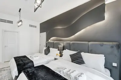 a bedroom with two beds with white and black pillows at Luxury 1BR on Marina Walk, Sea & Palm View-6 Sleep in Dubai