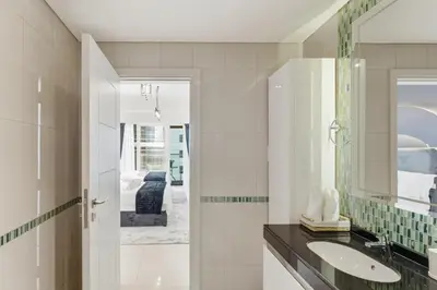 a bathroom with a sink and a mirror at Luxury 1BR on Marina Walk, Sea & Palm View-6 Sleep in Dubai