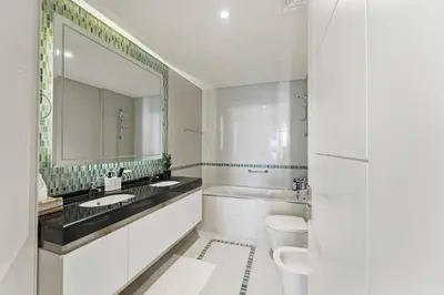 a white bathroom with a sink and a mirror at Luxury 1BR on Marina Walk, Sea & Palm View-6 Sleep in Dubai