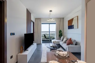 a living room with a couch and a table at 1BR plus Study Peaceful, Family-Friendly Community in Dubai