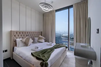 a bedroom with a large bed and a large window at 1BR plus Study Peaceful, Family-Friendly Community in Dubai