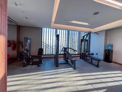 a gym with treadmills and cardio equipment in a building at 1BR plus Study Peaceful, Family-Friendly Community in Dubai