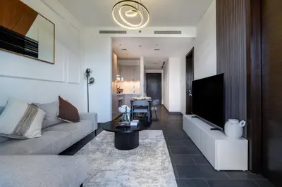 a living room with a couch and a table at 1BR plus Study Peaceful, Family-Friendly Community in Dubai