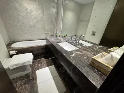 a bathroom with a sink and a toilet and a tub at FENDI 2BR- 67 Floor Sea, Atlantis & Dubai Eye View in Dubai