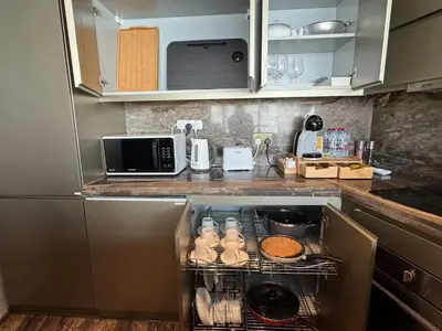 a kitchen with an oven with food in it at FENDI 2BR- 67 Floor Sea, Atlantis & Dubai Eye View in Dubai