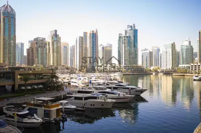 a group of boats docked in a harbor in a city at FENDI 2BR- 67 Floor Sea, Atlantis & Dubai Eye View in Dubai