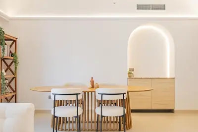 a kitchen with a round table and stools at Newly renovated, near the beach, with a Marina View in Dubai