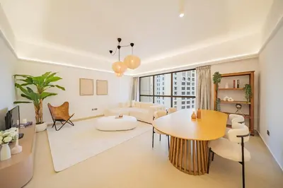a living room with a table and a couch at Newly renovated, near the beach, with a Marina View in Dubai