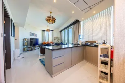 a kitchen with a large island in a room at Miracle View in Dubai