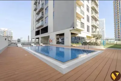 a swimming pool in the middle of a building at Vogue JVC Jeewar Tower near Circle Mall, One Bedroom Apartment with Balcony and City View, Access to all Amenities in Dubai