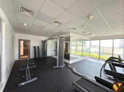 a gym with treadmills and machines in a room at Vogue JVC Jeewar Tower near Circle Mall, One Bedroom Apartment with Balcony and City View, Access to all Amenities in Dubai