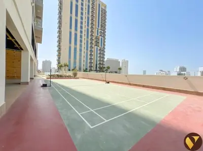 a tennis court in the middle of a building at Vogue JVC Jeewar Tower near Circle Mall, One Bedroom Apartment with Balcony and City View, Access to all Amenities in Dubai