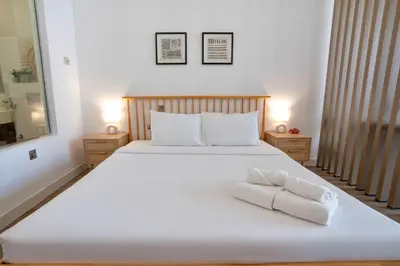 a bedroom with a large white bed with towels on it at Palm Jumeirah gem with direct beach access in Dubai