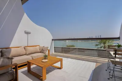a living room with a couch and a table at Palm Jumeirah gem with direct beach access in Dubai