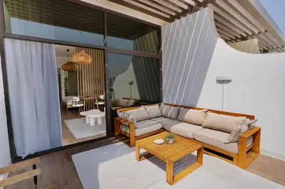 a living room with a couch and a table at Palm Jumeirah gem with direct beach access in Dubai