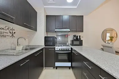 a kitchen with a sink and a stove top oven at Bloomfields Homey 1BR in Al Ramth 37 in Dubai