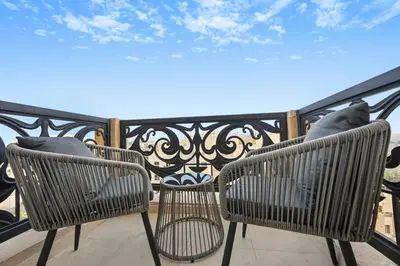 two chairs sitting on top of a balcony at Bloomfields Homey 1BR in Al Ramth 37 in Dubai