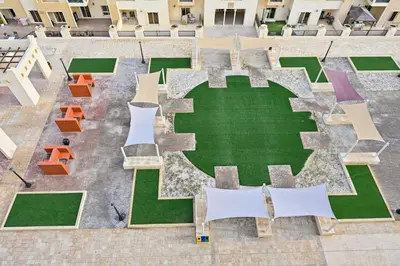 an overhead view of a courtyard with tables and chairs at Bloomfields Homey 1BR in Al Ramth 37 in Dubai