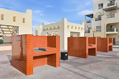 a brick wall in front of a building at Bloomfields Homey 1BR in Al Ramth 37 in Dubai