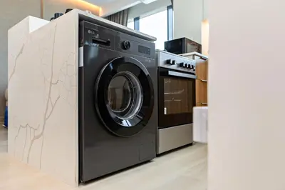 a washer and dryer in a room at Wonderful 1BR Apartment at East Crest in Dubai