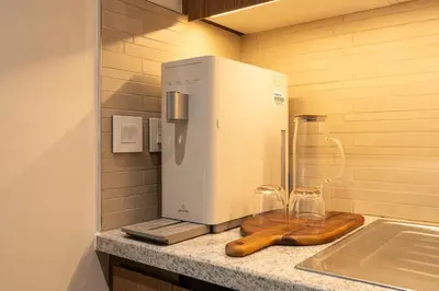 a kitchen with a counter top with a refrigerator at Seraya Residences at Downtown Views 1 in Dubai