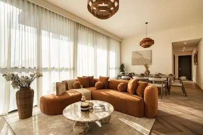 a living room with a couch and a table at Seraya Residences at Downtown Views 1 in Dubai