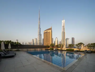 a swimming pool with a city skyline in the background at Seraya Residences at Downtown Views 1 in Dubai