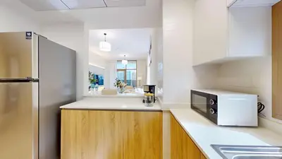 a kitchen with a sink and a microwave at Elegant 2BR Canal & Burj Khalifa View 1 in Dubai