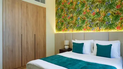 a bedroom with a bed with a painting on the wall at Elegant 2BR Canal & Burj Khalifa View 1 in Dubai