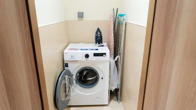 a washer and dryer in a small room at Elegant 2BR Canal & Burj Khalifa View 1 in Dubai