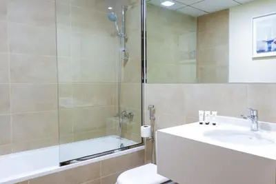 a bathroom with a sink and a shower and a toilet at Elegant 2BR Canal & Burj Khalifa View 1 in Dubai