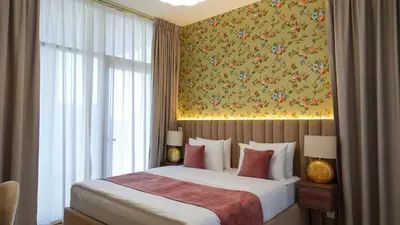 a bedroom with a bed with a floral wallpaper at Modern 3BR Full Canal & Burj Khalifa View 2 in Dubai